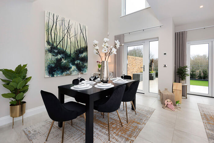 Professionally staged home by Beau Property Home Staging. Show home dining area featuring colour matched/themed furniture, dining set, white flower and large hanging painting