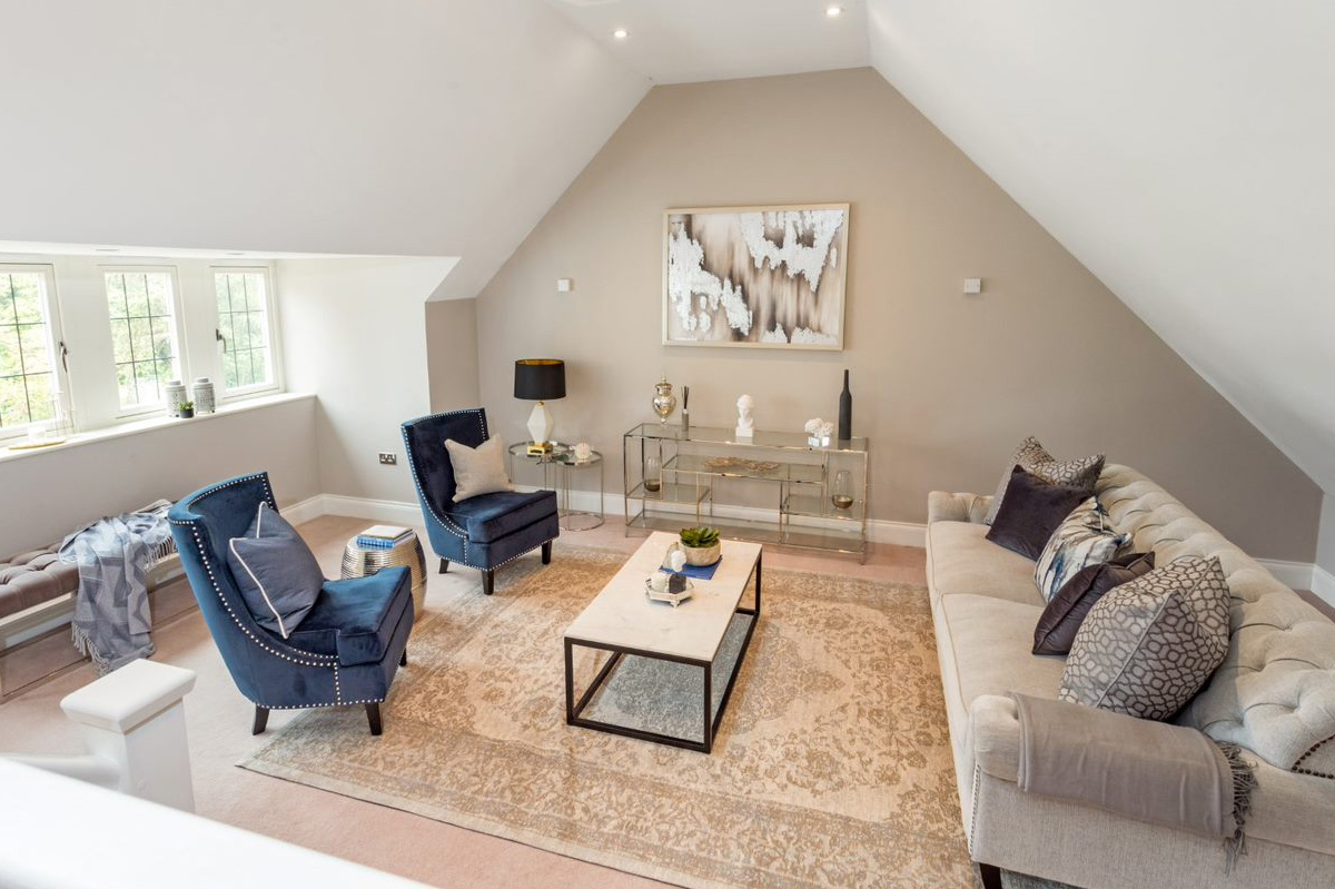 Professionally staged home by Beau Property Home Staging. Show home living area featuring colour matched/themed furniture, large wall art and two single seats