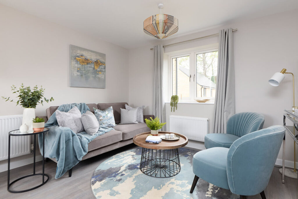Professionally staged home by Beau Property Home Staging. Show home lounge area, staged using living set and circle wooden table