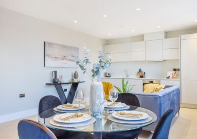 Staged dining table with kitchen in background