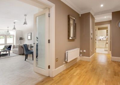 Professionally staged home by Beau Property Home Staging. Show home hallway looking into lounge area
