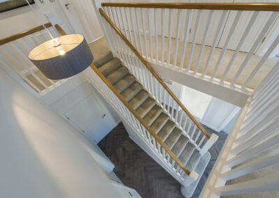Professionally staged home by Beau Property Home Staging. Show home stairs taken from landing