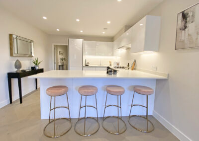 Professionally staged home by Beau Property Home Staging. Show home kitchen featuring bar stools