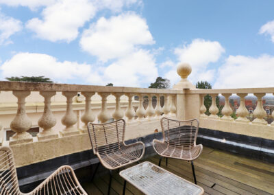 Professionally staged home by Beau Property Home Staging. Show home balcony featuring seating area