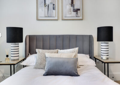 Professionally staged home by Beau Property Home Staging. Show bedroom featuring close up of staged bed