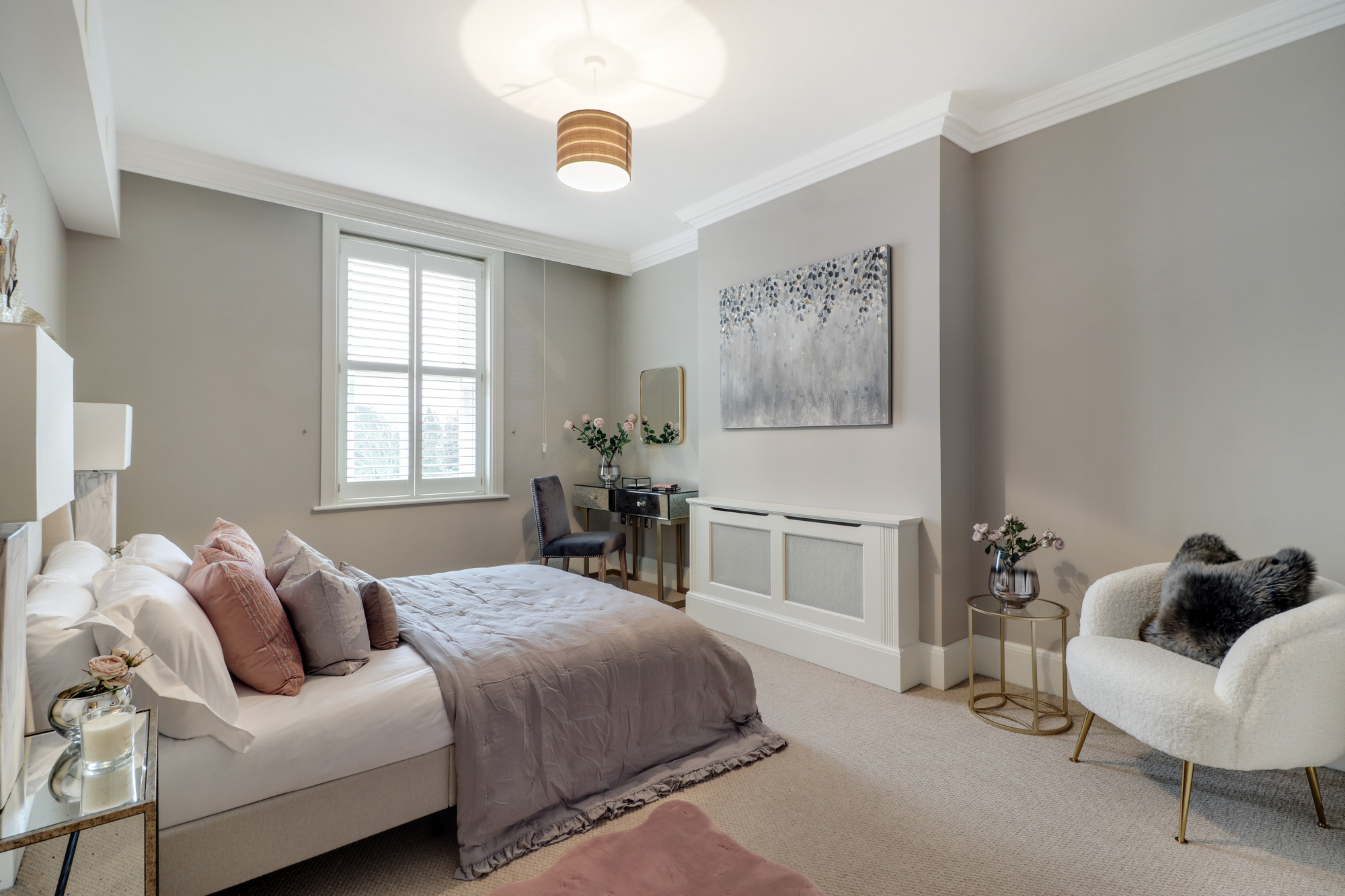 Professionally staged home by Beau Property Home Staging. Show bedroom featuring decorative lighting, mirrors, staged bed & dressing table