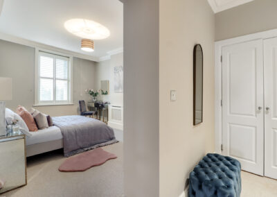 Professionally staged home by Beau Property Home Staging. Show bedroom featuring decorative lighting, mirrors, staged bed & dressing table