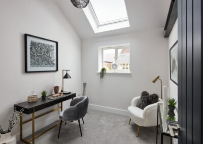 Professionally staged home by Beau Property Home Staging. Show home study room, featuring desk, designer chairs with reading lamp and artwork