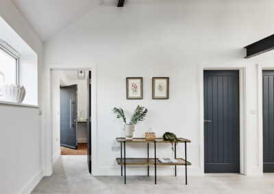 Professionally staged home by Beau Property Home Staging. Show home room, featuring minimalist details with several plants, ornaments and hanging artwork
