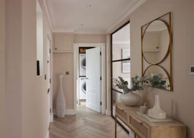 Inviting and elegant hallway leading to a modern laundry room in a staged home in Tunbridge Wells, exemplifying the attention to detail in home staging.